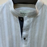 Cream with subtle white pinstripes